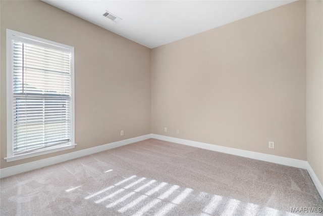 spare room with light carpet