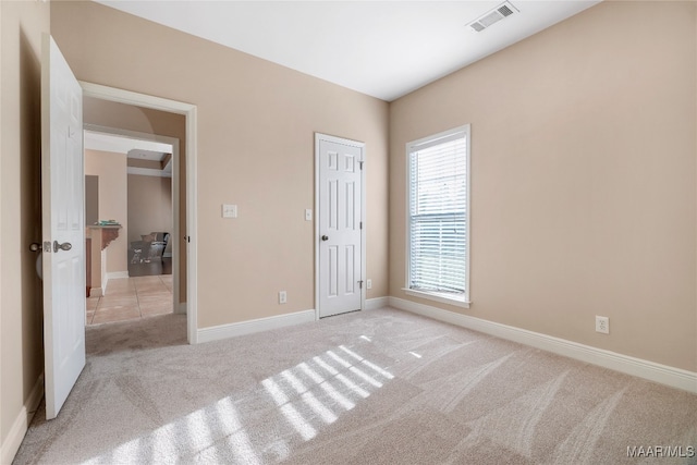 unfurnished bedroom with light colored carpet