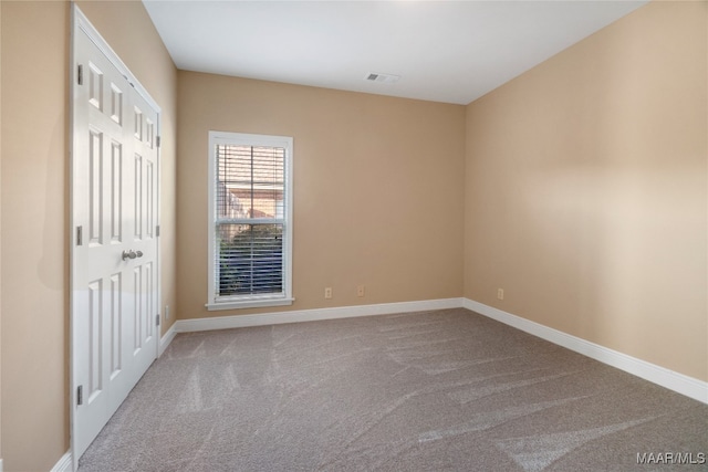 spare room featuring carpet floors