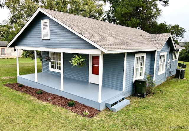 view of front facade with central AC unit and a front lawn