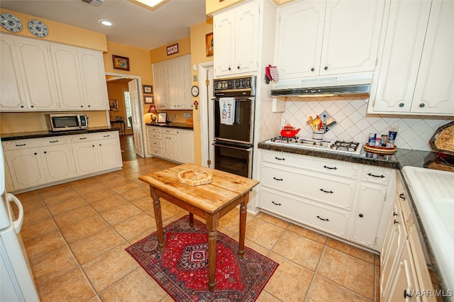 kitchen featuring black double oven, white cabinets, and light tile patterned floors