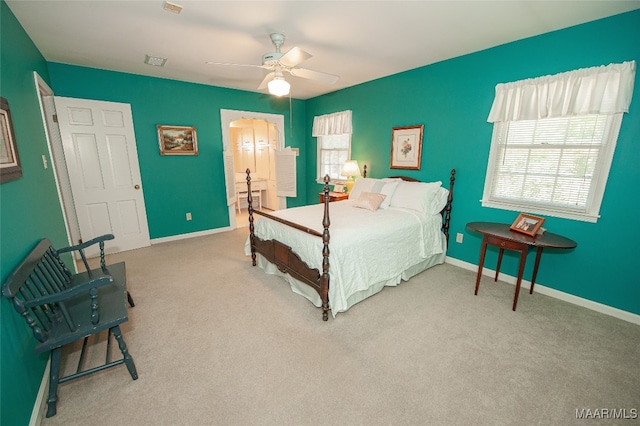 bedroom featuring ceiling fan and light carpet