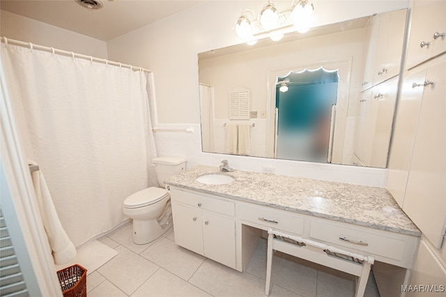 bathroom featuring tile patterned floors, vanity, and toilet