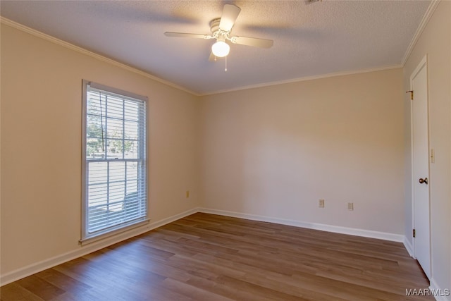 empty room with ceiling fan, wood-type flooring, and a textured ceiling