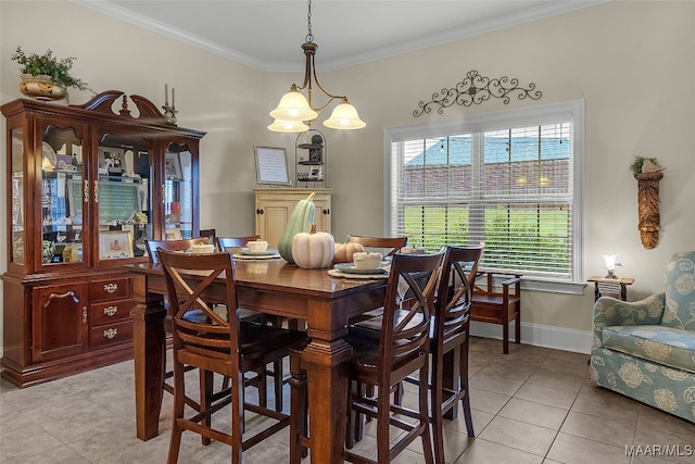 dining area featuring light tile patterned flooring, ornamental molding, and an inviting chandelier