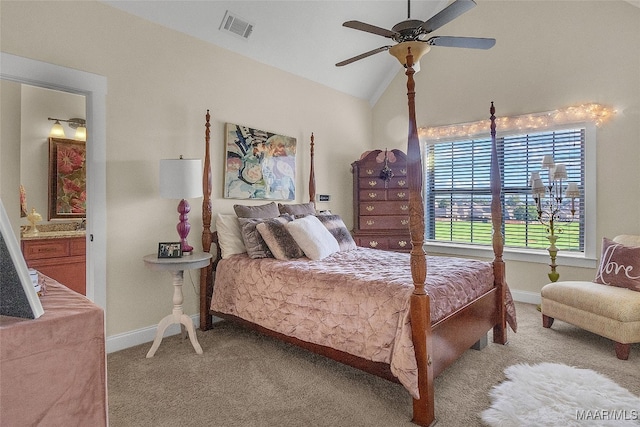 bedroom featuring light carpet, vaulted ceiling, ceiling fan, and ensuite bathroom