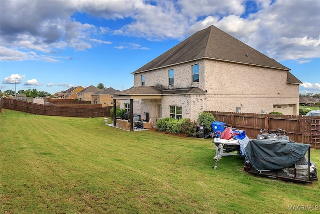 back of house with a yard and a patio area