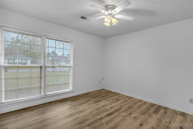 unfurnished room with wood-type flooring, crown molding, and ceiling fan