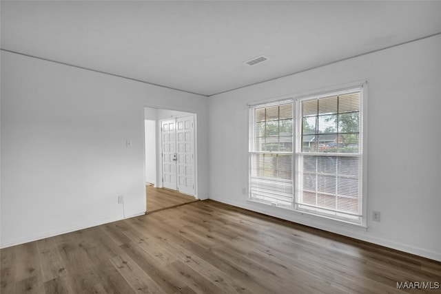 spare room with wood-type flooring