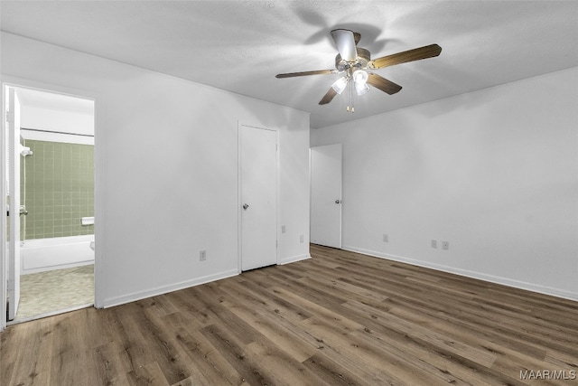 unfurnished room featuring ceiling fan and dark hardwood / wood-style floors