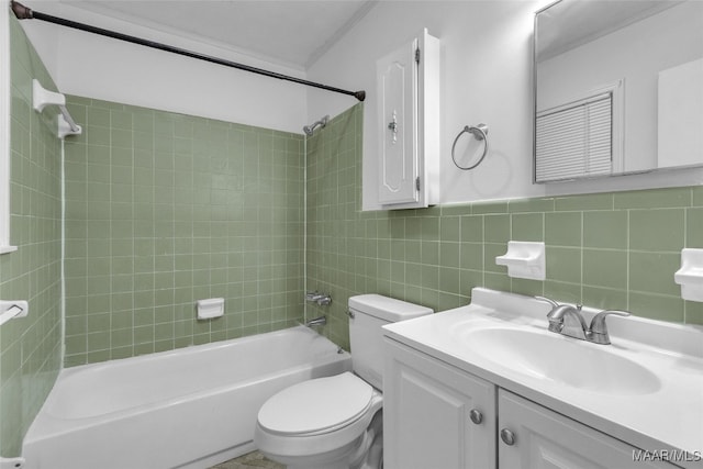 full bathroom featuring tile walls, vanity, tiled shower / bath combo, ornamental molding, and toilet