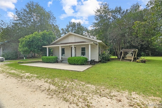 bungalow-style house featuring a front lawn and covered porch