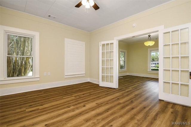 empty room featuring french doors, ornamental molding, baseboards, ceiling fan, and wood finished floors