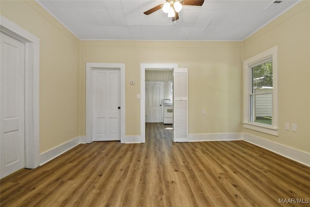 unfurnished room with a ceiling fan, crown molding, baseboards, and wood finished floors