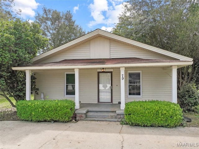 bungalow-style house with covered porch and roof with shingles