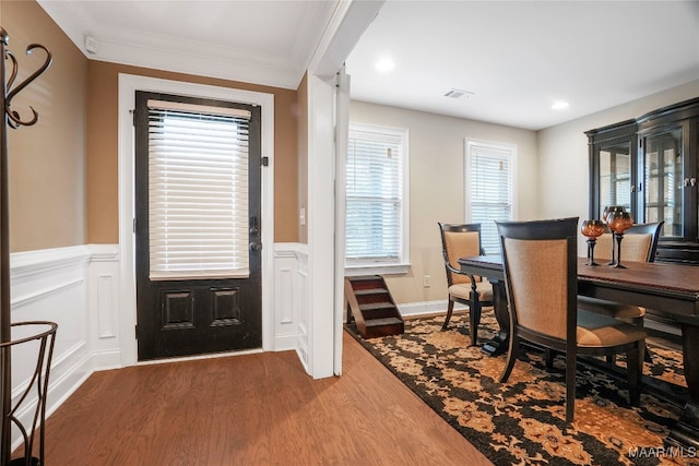 dining room featuring wood-type flooring and ornamental molding