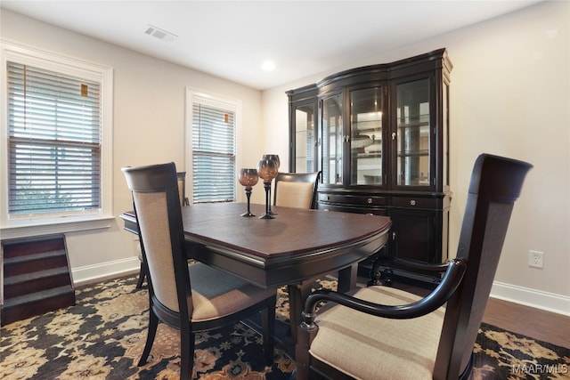 dining space featuring dark hardwood / wood-style floors and a wealth of natural light