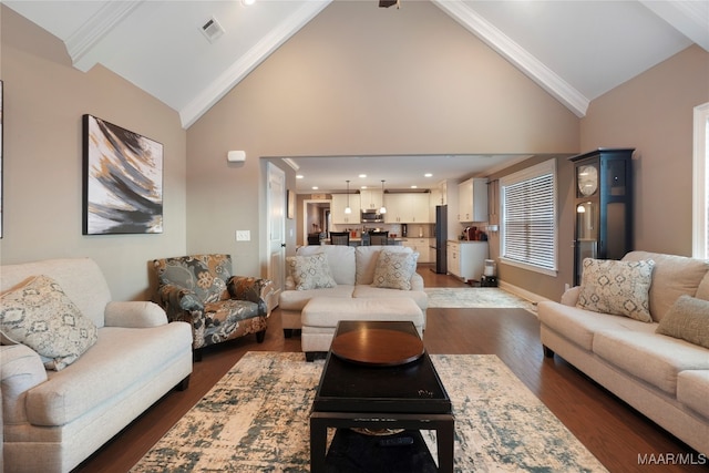 living room with crown molding, dark hardwood / wood-style flooring, and high vaulted ceiling