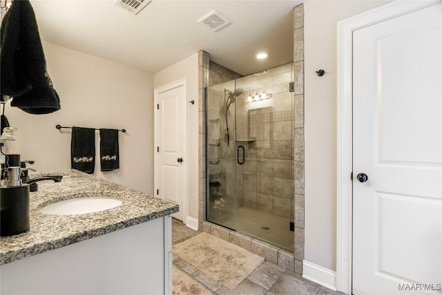 bathroom with vanity and a shower with shower door