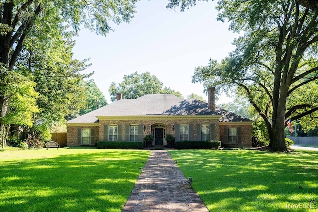 ranch-style home with a front lawn