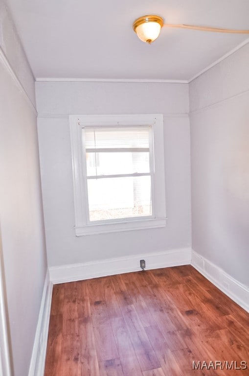 spare room with crown molding and hardwood / wood-style floors