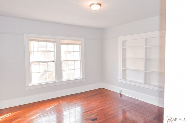 empty room with hardwood / wood-style flooring