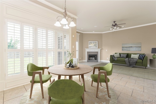 dining space featuring ceiling fan with notable chandelier, crown molding, and light tile patterned floors