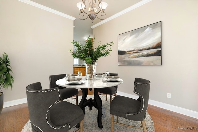 dining area with crown molding, dark hardwood / wood-style flooring, and a chandelier