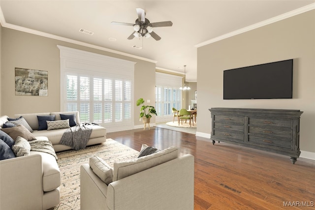 living room featuring crown molding, ceiling fan with notable chandelier, and dark hardwood / wood-style floors