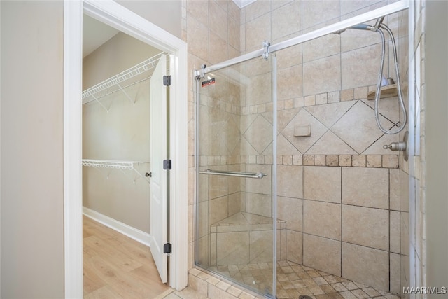 bathroom featuring hardwood / wood-style floors and an enclosed shower