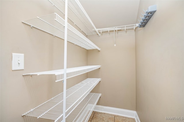 walk in closet with tile patterned floors