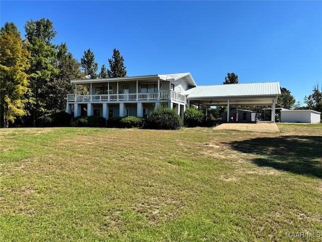 view of front of home with a front lawn and a carport