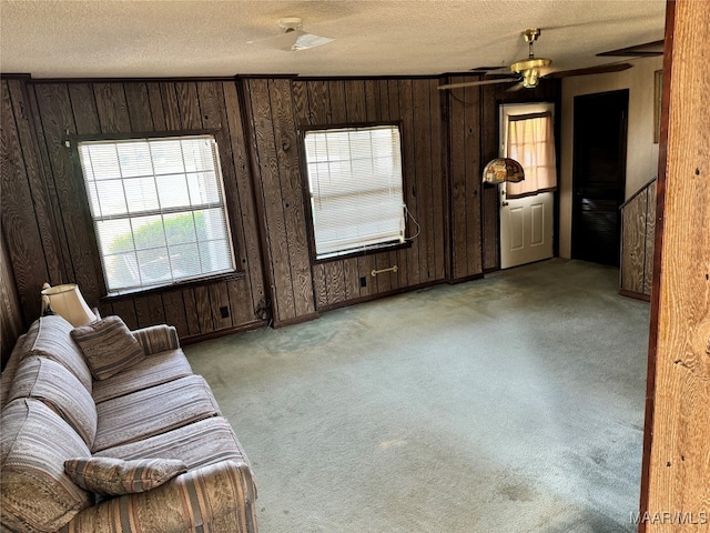 unfurnished living room with light carpet and a textured ceiling