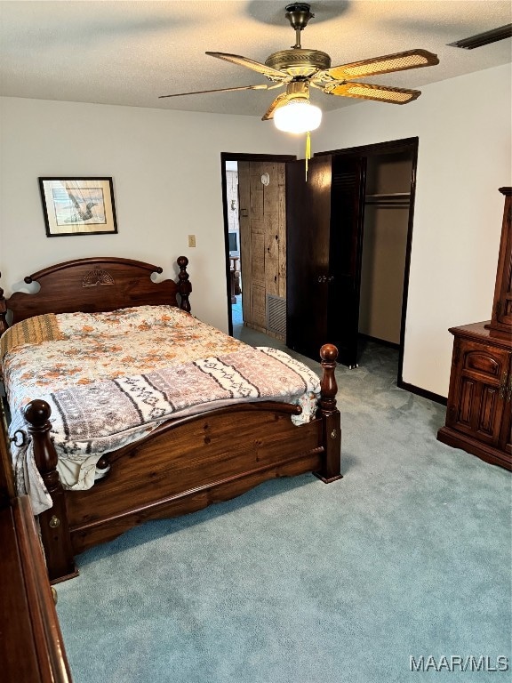 bedroom featuring a closet, ceiling fan, and light colored carpet