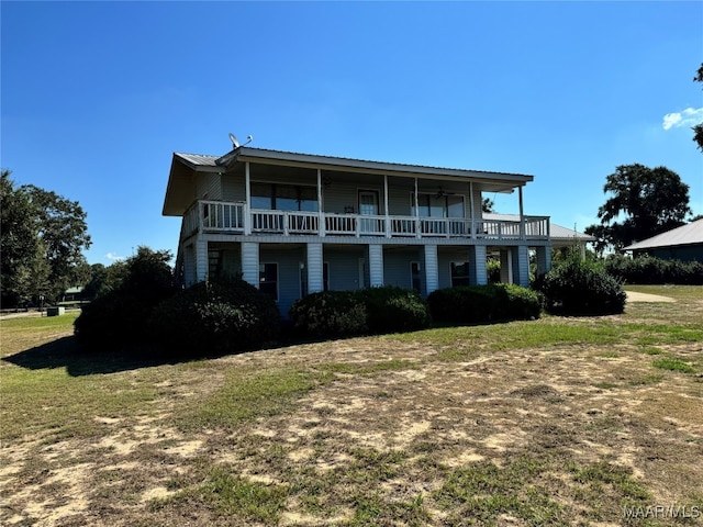 view of front of house featuring a front yard and a balcony