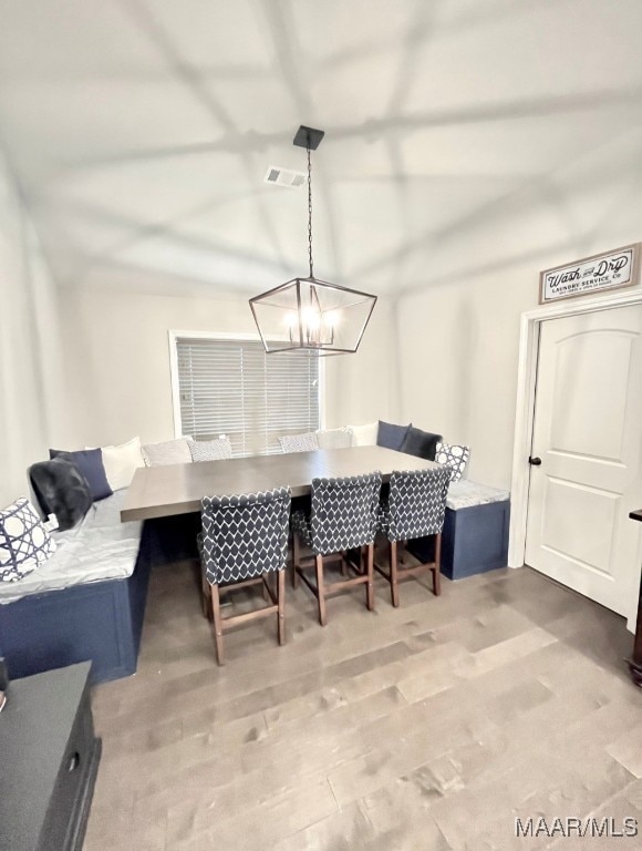 dining space with breakfast area and hardwood / wood-style flooring