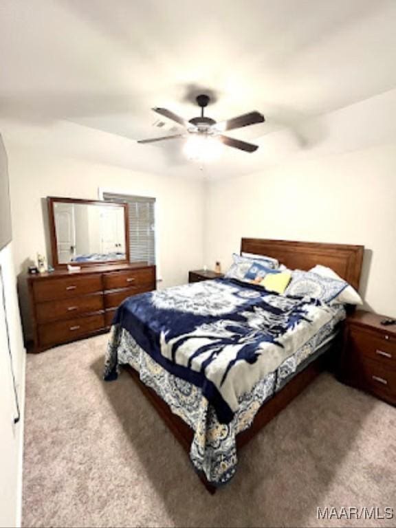bedroom featuring light colored carpet and ceiling fan