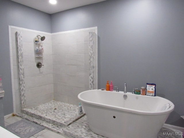 bathroom featuring independent shower and bath and tile patterned flooring