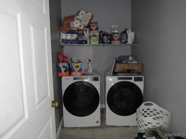 washroom with separate washer and dryer and light tile patterned flooring