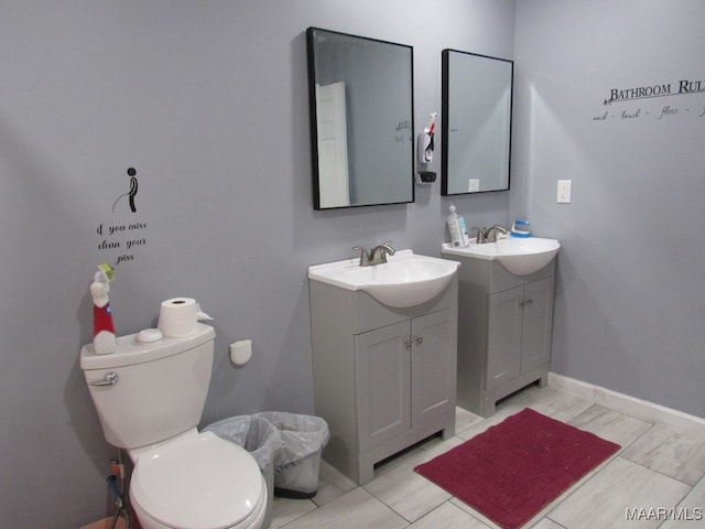 bathroom with tile patterned floors, vanity, and toilet