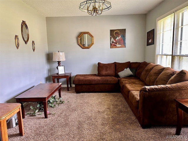 living room featuring a chandelier, a textured ceiling, and carpet flooring