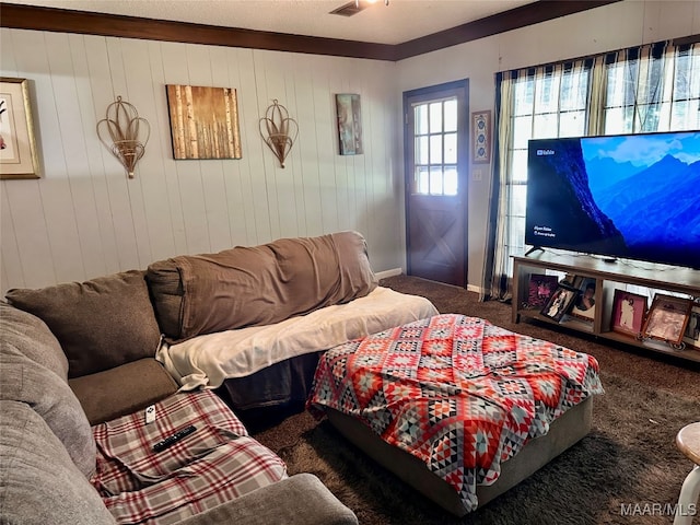 carpeted living room with wooden walls and ornamental molding