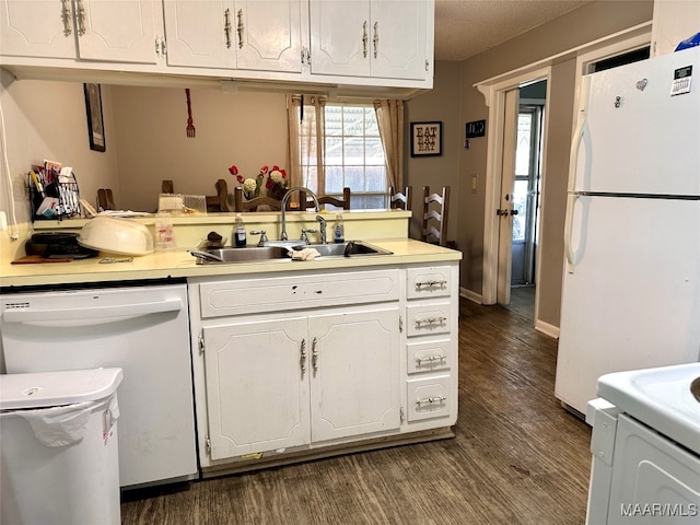 kitchen with white appliances, white cabinetry, dark wood-type flooring, and sink