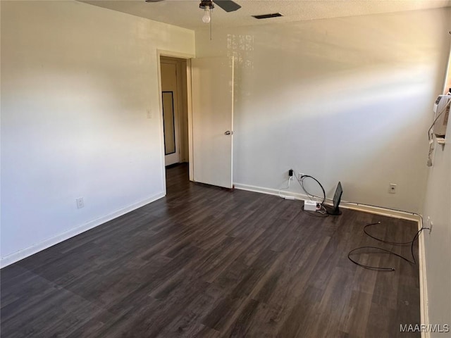 spare room with ceiling fan and dark hardwood / wood-style flooring