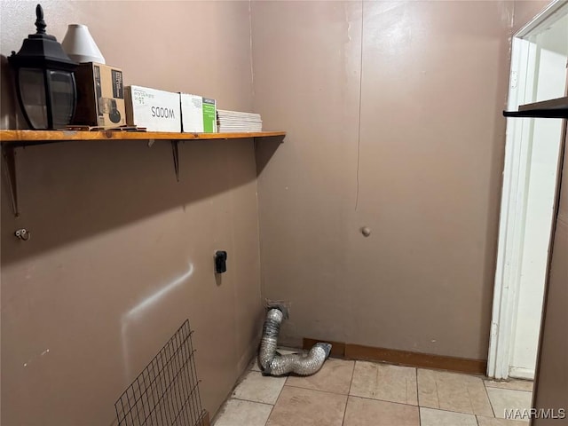 clothes washing area with light tile patterned floors