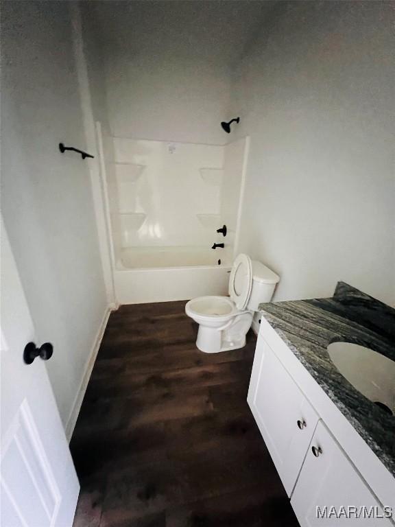 551 Butter And Egg Rd, Troy, AL 36081 - full bath featuring wood finished floors, toilet, tub / shower combination, and vanity