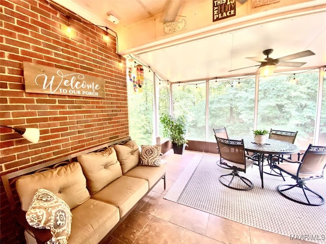 sunroom / solarium featuring ceiling fan