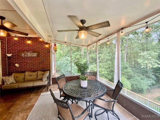 sunroom / solarium featuring ceiling fan