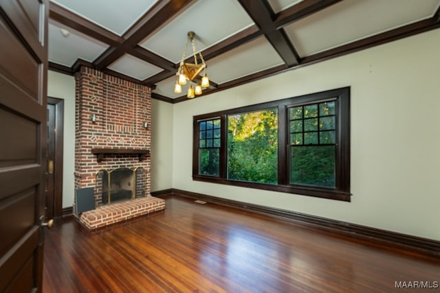 unfurnished living room featuring a fireplace, beamed ceiling, hardwood / wood-style floors, and coffered ceiling