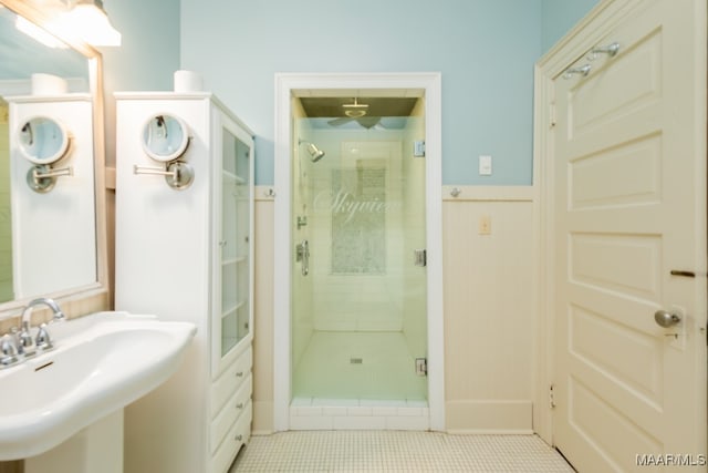 bathroom with sink, tile patterned flooring, and a shower with door